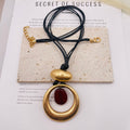 JI JOYA VENTA AL POR MAYOR|Collar de Moda Mayorista | Colgante Dorado con Piedra Resina (2 Colores: Borgoña / Verde Turquesa) | Cordón Negro Ajustable
